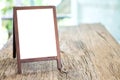 Mock up blank advertising whiteboard with easel standing on wood