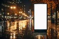 Mock up of a blank billboard on a city street at night Royalty Free Stock Photo