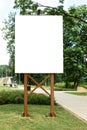 Mock up. Blank billboard outdoors, outdoor advertising, public information board in the city park Royalty Free Stock Photo