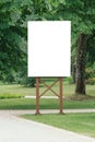 Mock up. Blank billboard outdoors, outdoor advertising, public information board in the city park Royalty Free Stock Photo