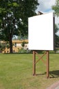 Mock up. Blank billboard outdoors, outdoor advertising, public information board in the city park Royalty Free Stock Photo