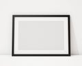 Mock up blank black horizontal picture frame on the white interior background