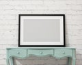 Mock up blank black picture frame on the white desk and wall, background Royalty Free Stock Photo