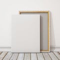 Mock up blank canvas or poster with pile of canvas on floor and wall, background