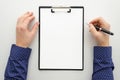 Mock up with blank clipboard with paper document, report ,man holding pen. Businnes office workspace mockup. Flat lay