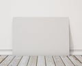 Mock up blank horizontal poster on the white wall and the wooden floor, background Royalty Free Stock Photo