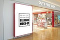 Mock up blank large billboard near entrance of duty free shop