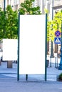 Mock up. Blank outdoor advertising column and billboard stand outdoors, public information board in the city. Royalty Free Stock Photo