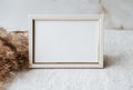 Mock up blank photo frame on table. Gray linen tablecloth fabric background. home office decor. With copy space.