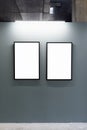 Mock up. Blank picture frames on gray wall in the loft interior. Gallery wall with empty poster frames indoor Royalty Free Stock Photo