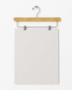 Mock up blank poster on clothes hanger hanging on the white wall, background Royalty Free Stock Photo