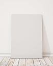 Mock up blank poster on the white wall and the wooden floor, background Royalty Free Stock Photo