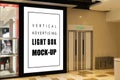 Mock up blank vertical light box at modern building