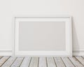 Mock up blank white horizontal picture frame on the wall and the vintage floor