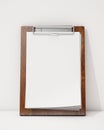 Mock up blank wooden clipboard ion the white wall and floor, background Royalty Free Stock Photo