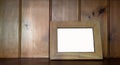 Mock up of blank  wooden picture frame on wooden counter  against wood  background Royalty Free Stock Photo