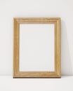 Mock up blank wooden picture frame on the wall and the floor