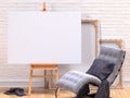 Mock up canvas frame with grey easy chair, easel, floor and wall. 3D