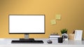 Mock up computer with blank white screen and Office Supply Items on Word Desk home decor with picture frame workspace Royalty Free Stock Photo