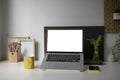 Computer laptop, Coffe cup, houseplant, smart phone and pencil holder on white desk.