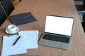 Computer laptop, coffee cup and documents on wooden table. Royalty Free Stock Photo