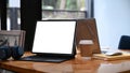 Computer tablet, coffee cup and wireless headphone on wooden table. Royalty Free Stock Photo