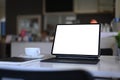 Computer tablet with empty screen, notebook and coffee cup on white table at kitchen room. Royalty Free Stock Photo