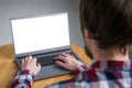 Man student typing on grey laptop computer keyboard with white blank screen Royalty Free Stock Photo