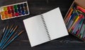 Mock up. Creative space. Artist workspace on vintage wooden table: watercolor, white paper, paint brushes, gouache paints. Royalty Free Stock Photo