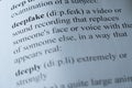 A dictionary page with the word deepfake with selective focussing