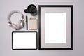 Digital tablet, empty picture frame, headphone and coffee cup on white background. Royalty Free Stock Photo