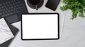 Digital tablet, mobile phone, notebook, coffee cup and houseplant on white table. Royalty Free Stock Photo