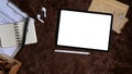 Top view digital tablet, wireless earphone, document and notebook on brown fur rug. Royalty Free Stock Photo
