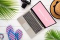 Mock up display of laptop on white wooden table for Summer Holiday Vacation background concept. Flat lay top view of Notebook Royalty Free Stock Photo