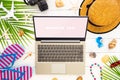 Mock up display of laptop on white wooden table for Summer Holiday Vacation concept. Flat lay top view of Notebook Laptop, palm Royalty Free Stock Photo