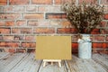 Mockup empty blank paper card on wooden easel with dried flowers bouquet Royalty Free Stock Photo