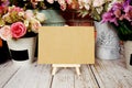 Mock up empty blank paper card on wooden easel with dried flowers bouquet Royalty Free Stock Photo