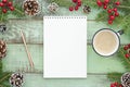 Mock up empty notebook on New Year`s background with fir tree pine cones and coffee cup . Flat lay Top view