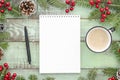 Mock-up empty notebook on New Year`s green wood background with fir tree pine cones and coffee cup . Flat lay Top view Royalty Free Stock Photo