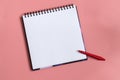 Mock up of empty scketchbook white paper on pastel pink background. One red wax crayon. Top view of open notebook with Royalty Free Stock Photo