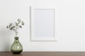 Mock up empty white frame background. Empty frame for a photo or painting in a light Scandinavian minimalist interior on
