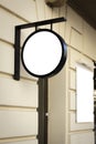 Mock up. Empty white round signage and vertical rectangular signboard on the wall of classical architecture building in Royalty Free Stock Photo