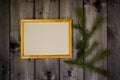Mock up empty wood frame and fir sprig on dark pine wood wall background, show text or product. Christmas theme Royalty Free Stock Photo