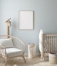 Mock up frame in boy nursery with natural wooden furniture Royalty Free Stock Photo