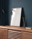 Mock-up frame in dark blue home interior with chest of drawers and decor Royalty Free Stock Photo