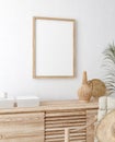 Mock up frame in home interior background, white room with natural wooden furniture, Scandi-Boho style Royalty Free Stock Photo