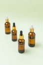 Mock up glass cosmetic brown bottles with a pipette on a mint background