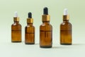 Mock up glass cosmetic brown bottles with a pipette on a mint background