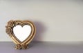 Mock up of gold heart shaped picture frame on modern counter Royalty Free Stock Photo