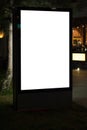 Mock up of Illuminated blank billboard in night city. Royalty Free Stock Photo